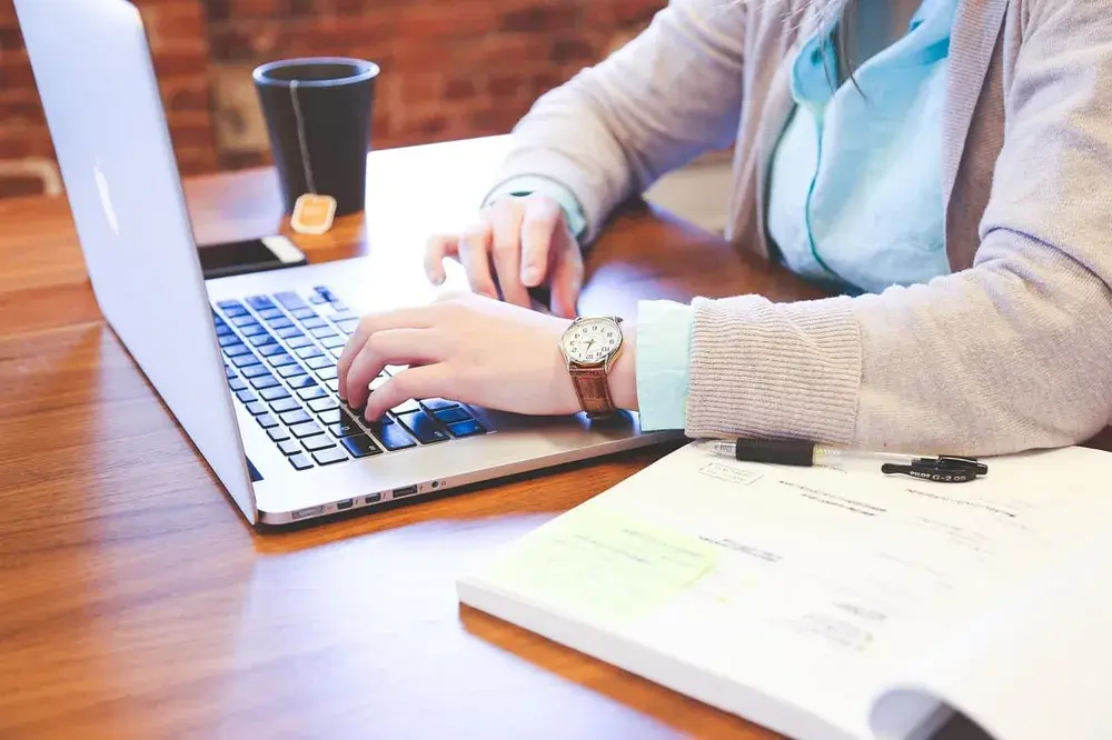 Illustrative photograph of a person reviewing information on a laptop; not an AKR client report